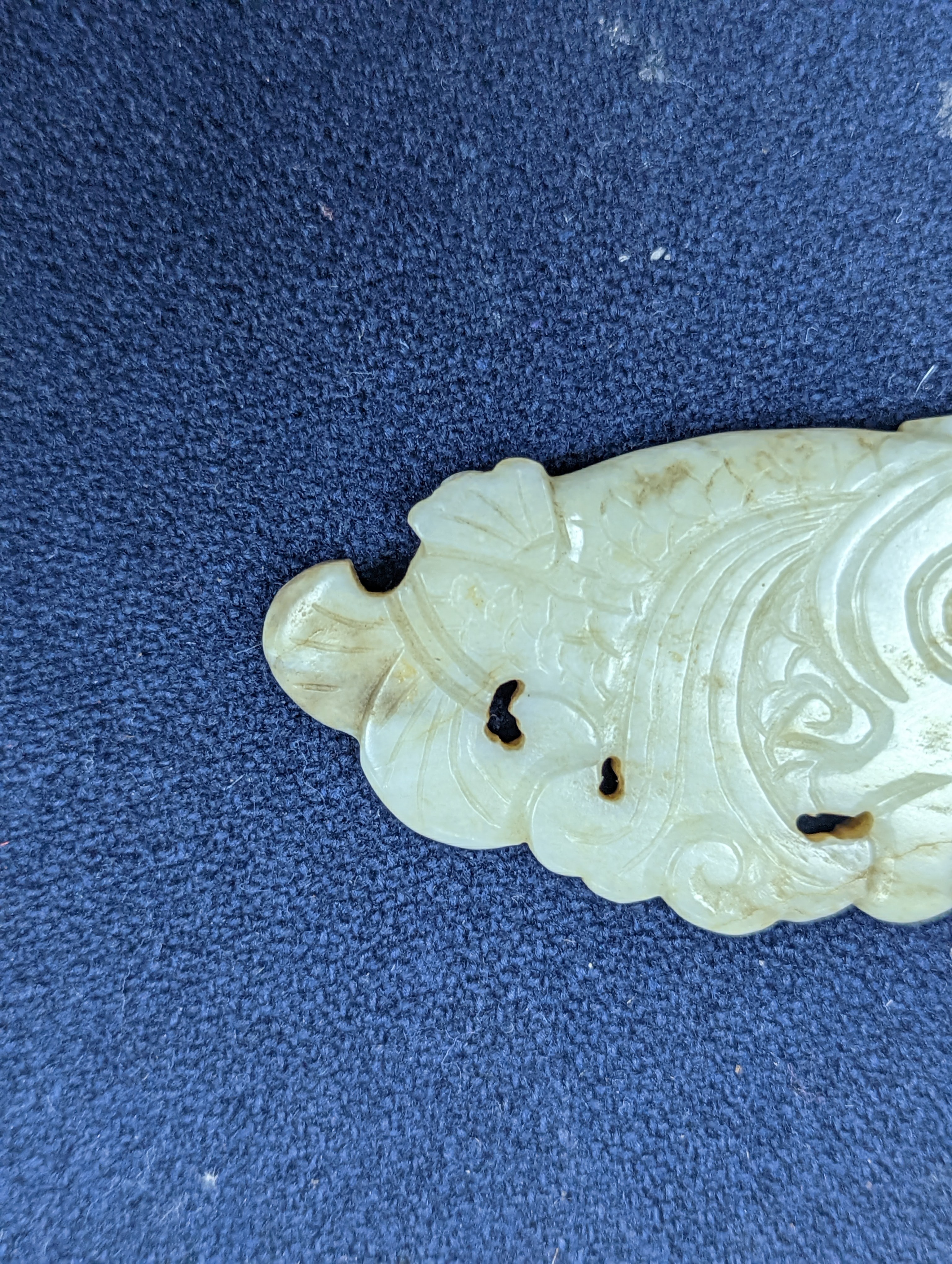 A Chinese white and black jade ‘dragon-fish’ plaque, 19th/20th century, 6cm